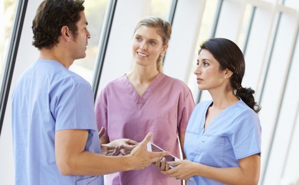 Medical Staff Talking In Hospital Corridor