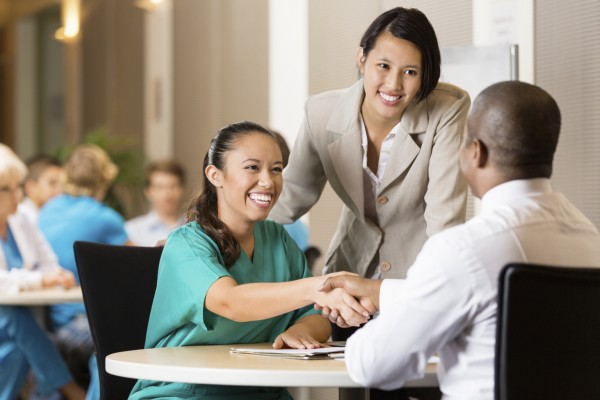 Hospital employee conducting job interview with nurse